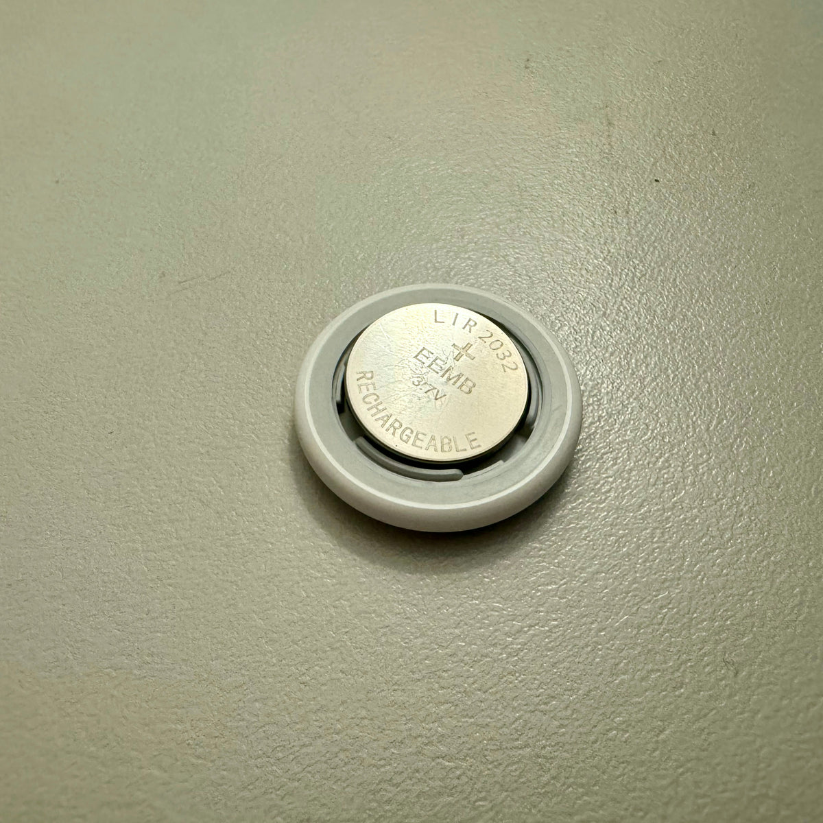 LIR2032 rechargeable battery fitted inside a tracking tag battery compartment