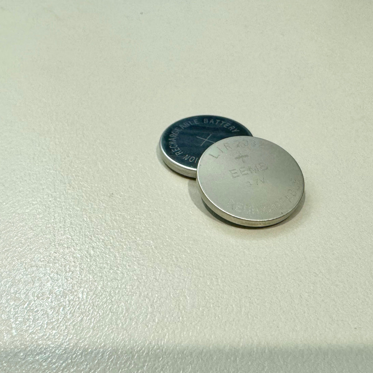 Two LIR2032 rechargeable coin cells, one resting on the other, 20mm diameter